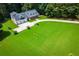 Wide-angle aerial view of property highlighting spacious lawn, circular driveway, and lush surrounding trees at 4149 Yancey Rd, Douglasville, GA 30135