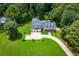 Aerial view of property showcasing manicured lawn, circular driveway and a beautiful in-ground pool at 4149 Yancey Rd, Douglasville, GA 30135