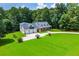 Expansive property featuring a large home with a three-car garage and a sprawling green lawn at 4149 Yancey Rd, Douglasville, GA 30135