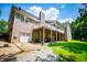 Spacious backyard with a large covered patio, garage, and well-maintained lawn at 4149 Yancey Rd, Douglasville, GA 30135