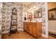 Elegant bathroom with decorative wallpaper, modern vanity, double sinks, and decorative elements at 4149 Yancey Rd, Douglasville, GA 30135