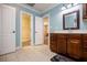 Well-lit bathroom features a vanity with drawers and a view to an adjacent room and closet at 4149 Yancey Rd, Douglasville, GA 30135