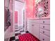Pink bathroom with vanity and black and white checkered floor, zebra-print accessories at 4149 Yancey Rd, Douglasville, GA 30135