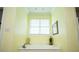 Bathroom tub and fixtures, with ample sunlight at 4149 Yancey Rd, Douglasville, GA 30135