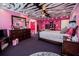 Vibrant pink bedroom featuring a unique zebra-striped ceiling, polka dot accents and dark furniture at 4149 Yancey Rd, Douglasville, GA 30135