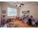 Playroom/bedroom featuring a ceiling fan, toys, decorations, a window and wood flooring at 4149 Yancey Rd, Douglasville, GA 30135