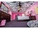 Fun pink bedroom with zebra-striped ceiling, polka dot accents, and dark wood furniture at 4149 Yancey Rd, Douglasville, GA 30135