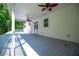 The covered patio features a ceiling fan, and is perfect for relaxing outdoors at 4149 Yancey Rd, Douglasville, GA 30135