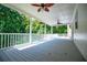 This covered patio features ceiling fans and overlooks the wooded backyard at 4149 Yancey Rd, Douglasville, GA 30135