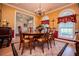 Elegant dining room with wood table, chandelier, and large windows at 4149 Yancey Rd, Douglasville, GA 30135