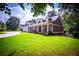 Charming home featuring a beautiful lawn, covered front porch, and well-manicured landscaping at 4149 Yancey Rd, Douglasville, GA 30135