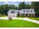 Charming home featuring a spacious front yard, long driveway and inviting front porch with columns at 4149 Yancey Rd, Douglasville, GA 30135