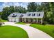Charming home featuring a spacious front yard, long driveway and inviting front porch with columns at 4149 Yancey Rd, Douglasville, GA 30135