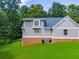 Well-maintained exterior featuring neutral siding, brick foundation, and large, green lawn at 4149 Yancey Rd, Douglasville, GA 30135