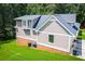 An exterior side-angle view of this lovely two-story home with neutral colored siding at 4149 Yancey Rd, Douglasville, GA 30135