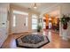 Bright foyer featuring hardwood floors, a stylish rug, and a view of the adjacent dining area at 4149 Yancey Rd, Douglasville, GA 30135