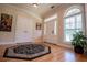 Elegant foyer with hardwood floors, stylish rug, and a window providing natural light at 4149 Yancey Rd, Douglasville, GA 30135