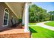 Inviting front porch with classic columns and a charming view of the surrounding landscape at 4149 Yancey Rd, Douglasville, GA 30135