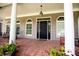 Charming covered porch with brick flooring and a welcoming entrance to the home at 4149 Yancey Rd, Douglasville, GA 30135
