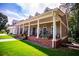 Inviting front porch features classic columns, black rocking chairs, and well-placed flower boxes at 4149 Yancey Rd, Douglasville, GA 30135