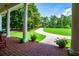Welcoming brick porch featuring rocking chairs and a view of the long, tree-lined driveway at 4149 Yancey Rd, Douglasville, GA 30135