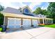 Spacious three-car garage with ample parking space and an attached home featuring a welcoming front porch at 4149 Yancey Rd, Douglasville, GA 30135
