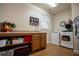 Bright laundry room featuring built-in cabinets, modern washer and dryer, and neutral walls at 4149 Yancey Rd, Douglasville, GA 30135