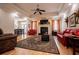 Spacious living room with fireplace, hardwood floors, and tray ceiling at 4149 Yancey Rd, Douglasville, GA 30135