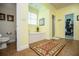 Well-lit main bathroom with tile flooring, a garden tub, and access to a walk-in closet at 4149 Yancey Rd, Douglasville, GA 30135