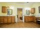 Dual vanities, tile floor, and warm lighting create a luxurious main bathroom at 4149 Yancey Rd, Douglasville, GA 30135
