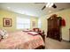 Relaxing main bedroom bathed in warm light, featuring a wooden bed frame and wardrobe at 4149 Yancey Rd, Douglasville, GA 30135