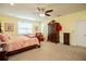 Spacious main bedroom with a ceiling fan and antique wardrobe at 4149 Yancey Rd, Douglasville, GA 30135