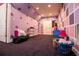 Attic space room with whimsical lavender walls decorated with purple stars and geometric shapes at 4149 Yancey Rd, Douglasville, GA 30135