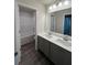Well-lit bathroom with double vanity, modern fixtures, and separate tub and shower at 4517 Ajo Walk, Atlanta, GA 30331