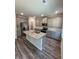 Spacious kitchen featuring gray cabinets, granite countertops, stainless appliances, and center island at 4517 Ajo Walk, Atlanta, GA 30331