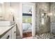 Chic bathroom featuring a walk-in shower, stylish vanity, and a peek into the Primary bedroom at 1100 Wylie Se St # A, Atlanta, GA 30316