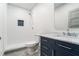 Bathroom featuring tiled shower with a rainfall showerhead, toilet, and vanity with marble countertop at 1100 Wylie Se St # A, Atlanta, GA 30316