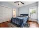 Bedroom featuring a queen size bed with a blue cover, hardwood floors, and a ceiling fan at 1100 Wylie Se St # A, Atlanta, GA 30316