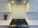 Stove with stainless steel hood, quartz countertops, and subway tile backsplash at 1100 Wylie Se St # A, Atlanta, GA 30316