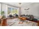 Cozy living room with large windows, a comfortable sofa, chairs and stylish area rug at 1100 Wylie Se St # A, Atlanta, GA 30316
