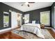 Inviting main bedroom with hardwood floors, barn door leading to ensuite bath, and neutral decor at 1100 Wylie Se St # A, Atlanta, GA 30316