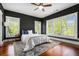 Bright bedroom with large windows, hardwood floors, and a comfortable bed dressed with plush bedding at 1100 Wylie Se St # A, Atlanta, GA 30316