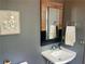 Chic powder room with a contemporary vanity, unique framed mirror, and neutral gray walls at 1100 Wylie Se St # A, Atlanta, GA 30316