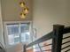 Sunlit staircase enhanced by modern globe lighting and an exterior view from a large window at 1100 Wylie Se St # A, Atlanta, GA 30316