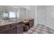 Bright bathroom featuring double vanity, decorative mirrors, and checkered tile flooring at 4279 Two Bridge Dr, Buford, GA 30518