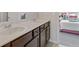 Bathroom vanity with double sinks, neutral paint and access to additional bedroom at 4279 Two Bridge Dr, Buford, GA 30518