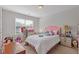 View of the bedroom featuring a pink headboard, window, and neutral walls at 4279 Two Bridge Dr, Buford, GA 30518