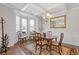 Elegant dining room with wainscoting, coffered ceiling, and stylish chandelier over a wood table at 4279 Two Bridge Dr, Buford, GA 30518
