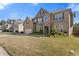 Attractive two-story brick and stone home with a well-kept lawn and colorful flower beds at 4279 Two Bridge Dr, Buford, GA 30518