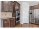 Modern kitchen with stainless steel appliances and beautiful dark wood cabinetry at 4279 Two Bridge Dr, Buford, GA 30518